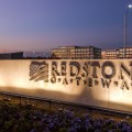 Redstone Gateway entrance sign with office buildings in background