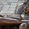 Bronze Statue of a boy reading at The Shoppes at River Crossing